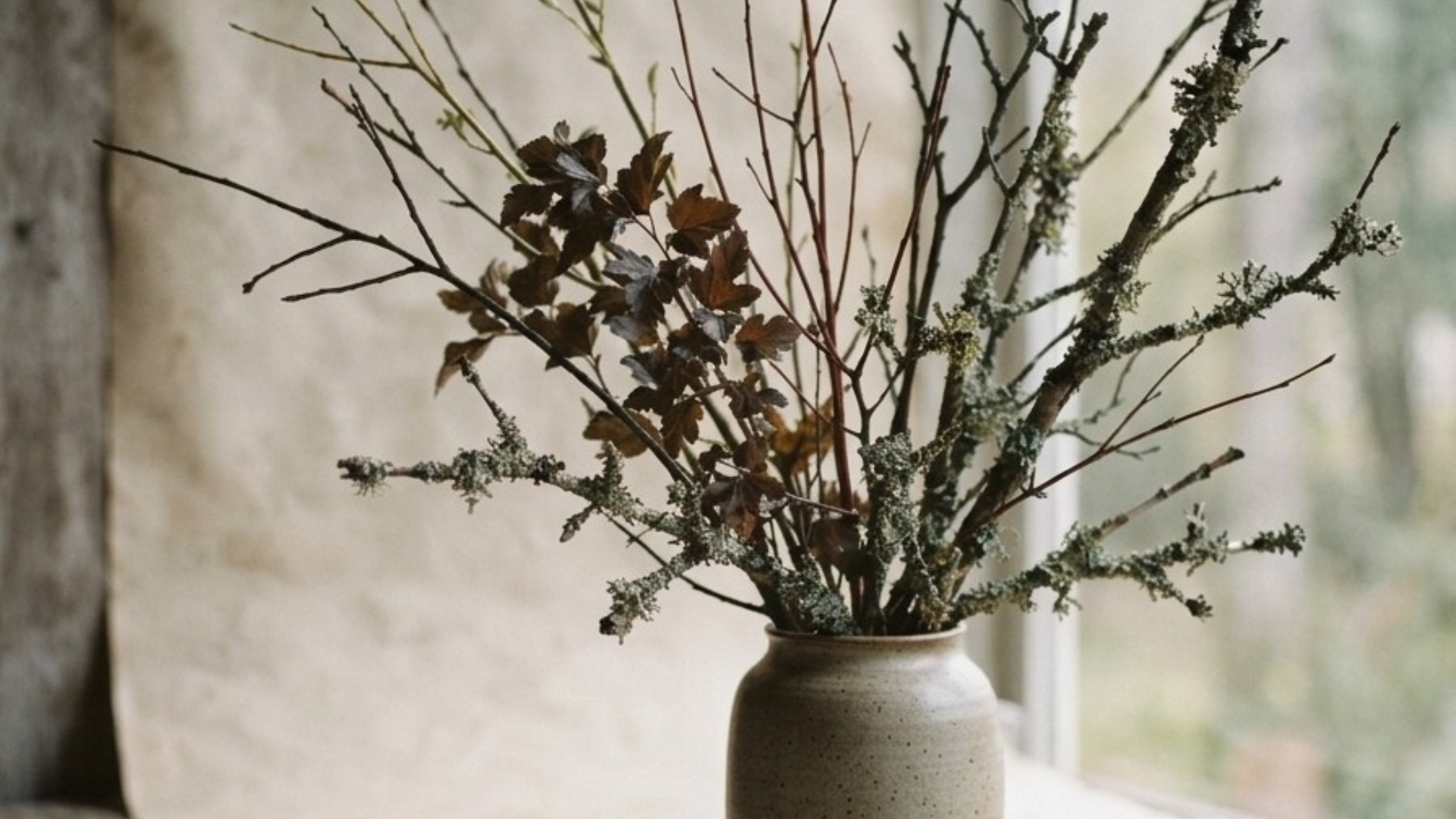Pacific Northwest woodland still life featuring lichen‑covered branches, red twig dogwood, and muted seasonal textures arranged on a soft neutral backdrop, showcasing transitional tones for floral designers.